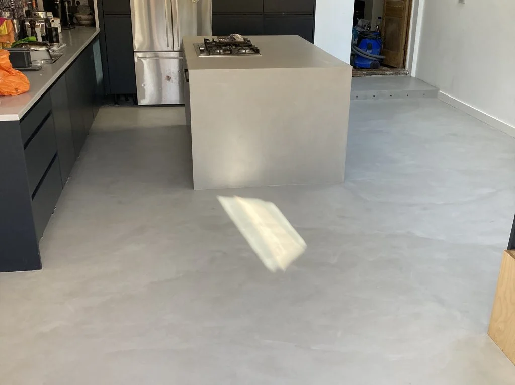Mid grey microcement kitchen floor and island
